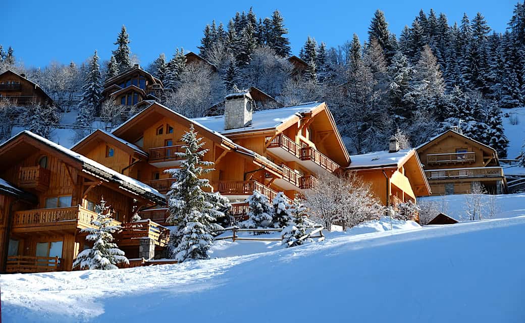 Alpine wooden chalet in the sunny mountains in winter, Meribel, Three Valleys, France