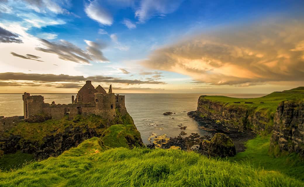 Beautiful overview of Ireland with waterscape, rock castle and sunset