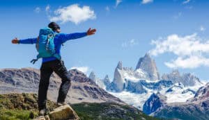 Active hiker hiking, enjoying the view, looking at Patagonia mountain landscape. Fitz Roy, Argentina.