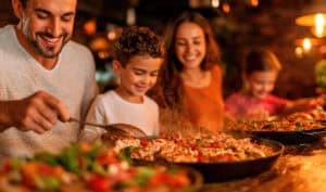 Happy family enjoying dinner at a rustic restaurant in Venice, Italy